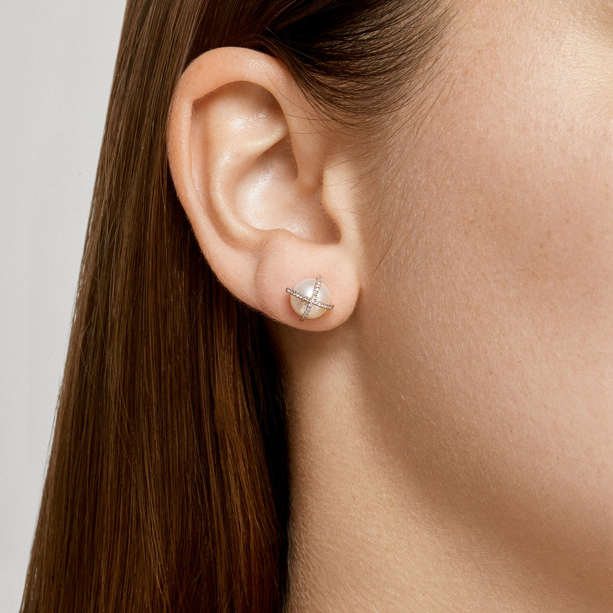 Model wearing 14KT Yellow Gold Diamond X Pearl Stud Earrings