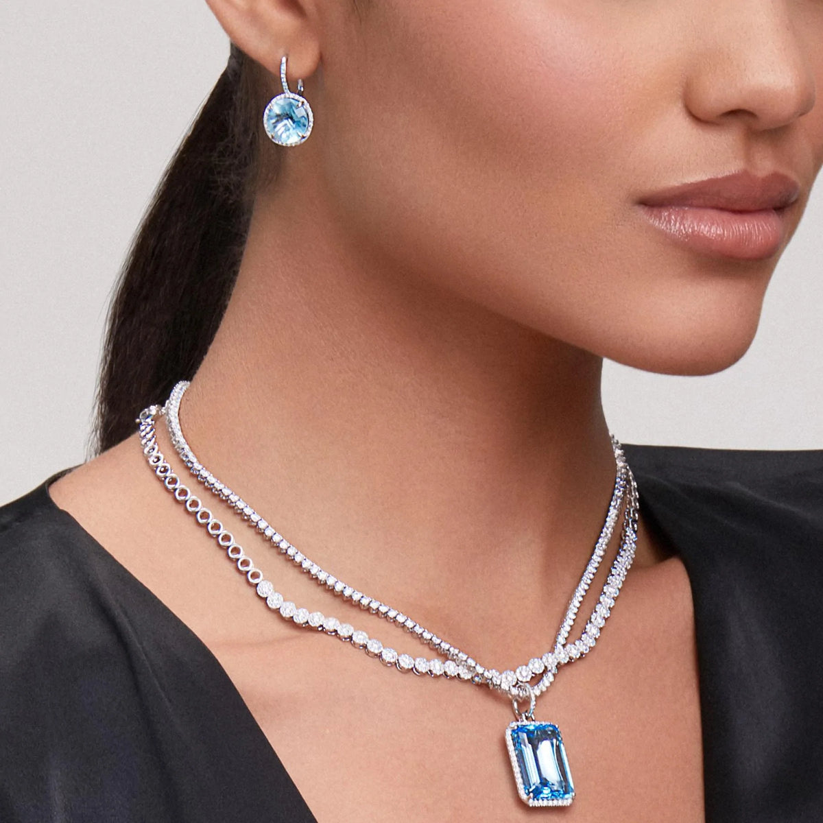 Model wearing 18KT Yellow Gold Diamond Blue Topaz Luxe Jolly Charm Pendant with Diamond Clip on Bail