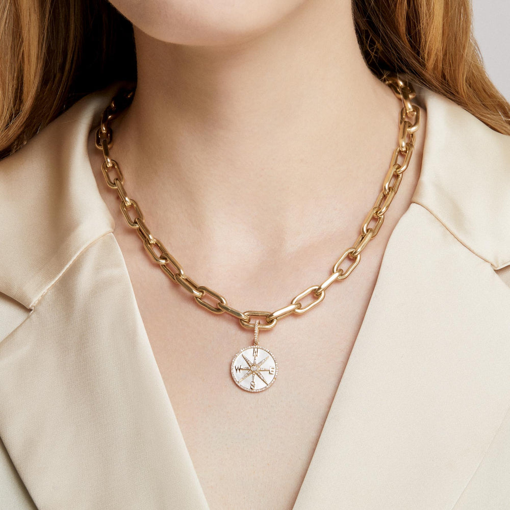 Model wearing 14KT Yellow Gold Mother of Pearl Diamond Compass Charm with Diamond Clip on Bail