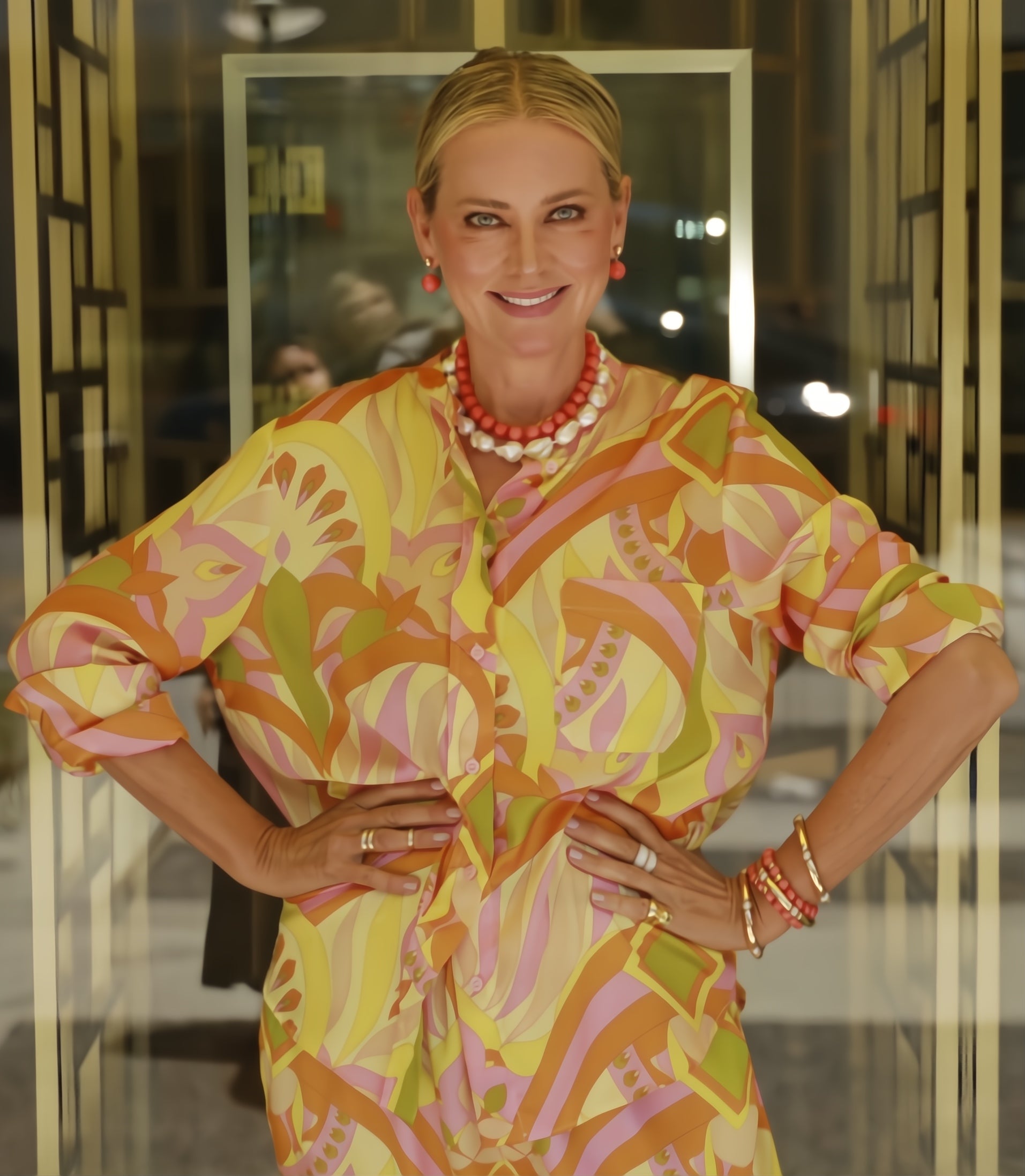 Anne Sisteron wearing coral & pearl necklaces with gold cabo bracelet and diamond rings